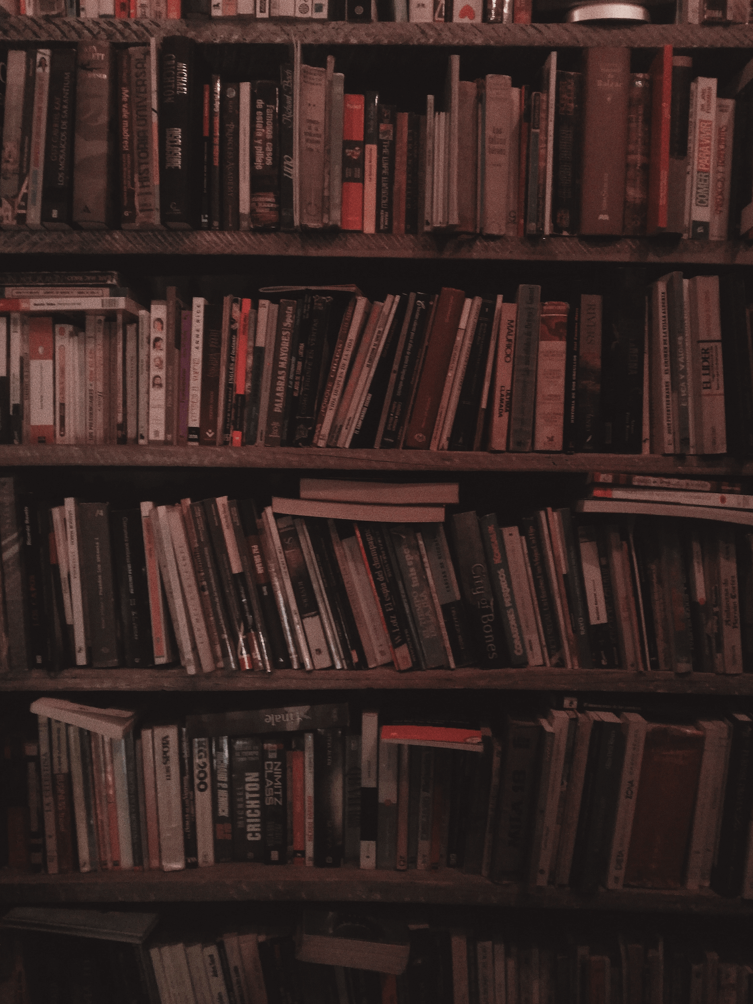 Books stacked tightly in an old bookshelf