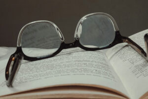 A pair of upside down glasses on top of an open book
